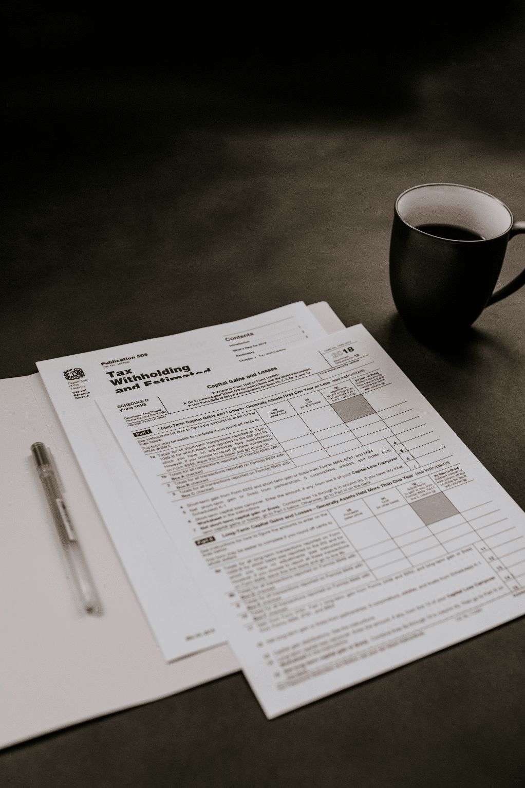  Tax reports lying next to coffee.